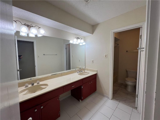 bathroom featuring vanity, tile patterned floors, a textured ceiling, and toilet