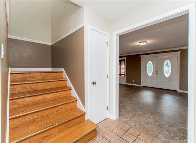 3412 Tolmas Dr, Metairie, LA 70002 - entryway featuring baseboards, stairs, light tile patterned flooring, and ornamental molding