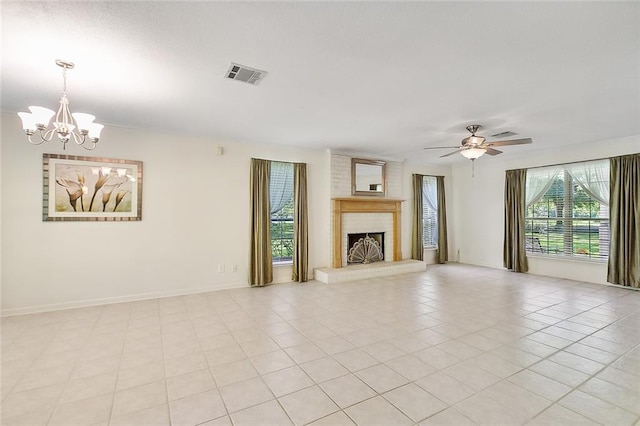 unfurnished living room featuring ceiling fan with notable chandelier, light tile patterned floors, and a fireplace