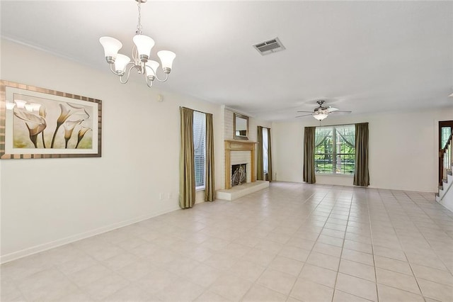 unfurnished living room with a large fireplace and ceiling fan with notable chandelier