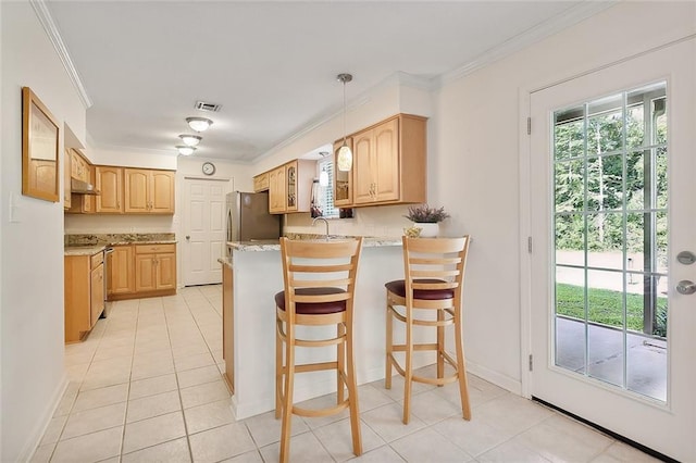 kitchen with stainless steel fridge, hanging light fixtures, a kitchen breakfast bar, light stone countertops, and kitchen peninsula