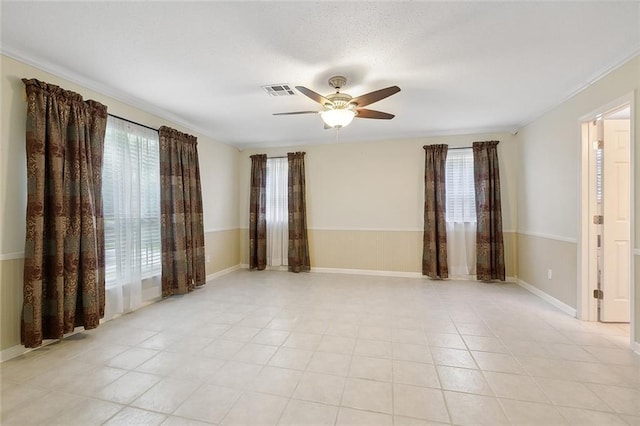 unfurnished room with ceiling fan and light tile patterned floors