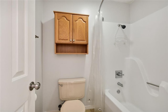 bathroom with shower / tub combo with curtain and toilet