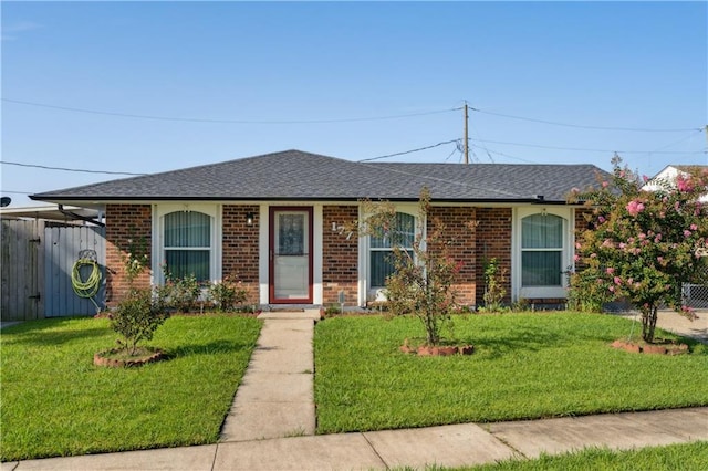 ranch-style home with a front lawn