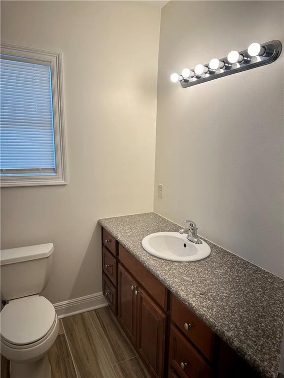 bathroom featuring hardwood / wood-style floors, vanity, and toilet