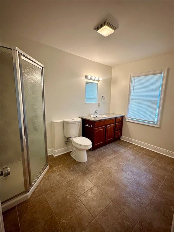 bathroom featuring tile patterned floors, vanity, an enclosed shower, and toilet