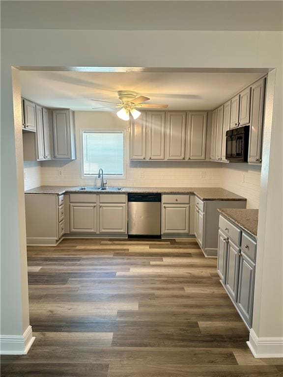 kitchen with gray cabinets, stainless steel dishwasher, ceiling fan, hardwood / wood-style floors, and sink