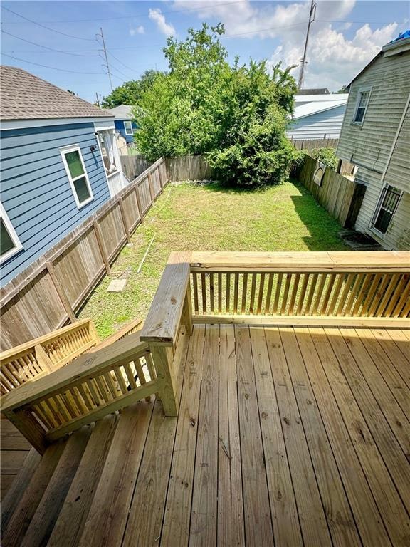 wooden deck with a lawn