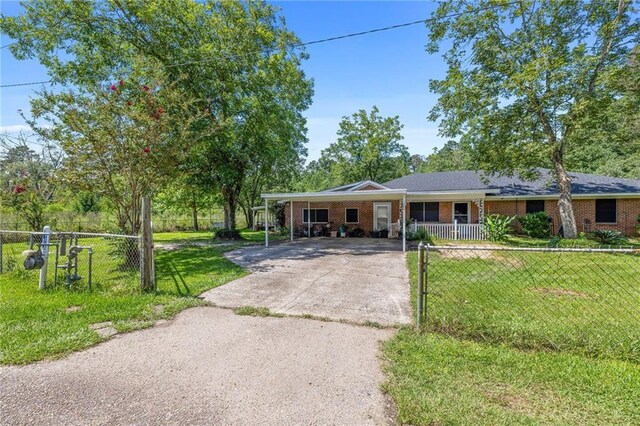 ranch-style house with a carport and a front yard