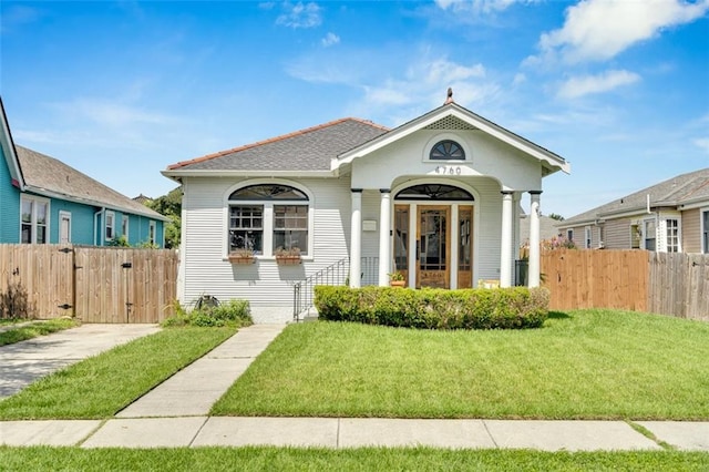 bungalow-style home with a front lawn