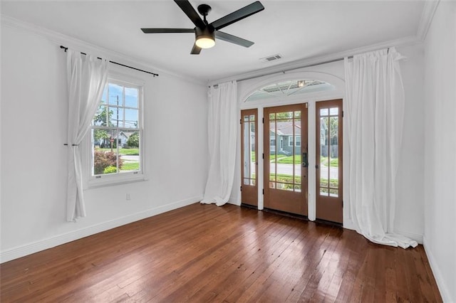 empty room with crown molding, ceiling fan, and dark hardwood / wood-style floors