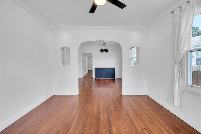 spare room featuring ceiling fan, ornamental molding, and wood-type flooring