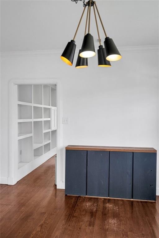 interior space with crown molding, dark wood-type flooring, and a chandelier