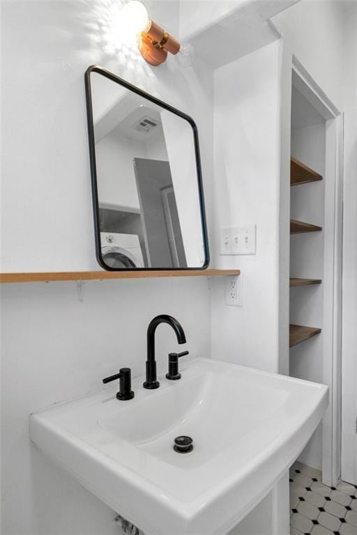 bathroom with sink and washer / clothes dryer