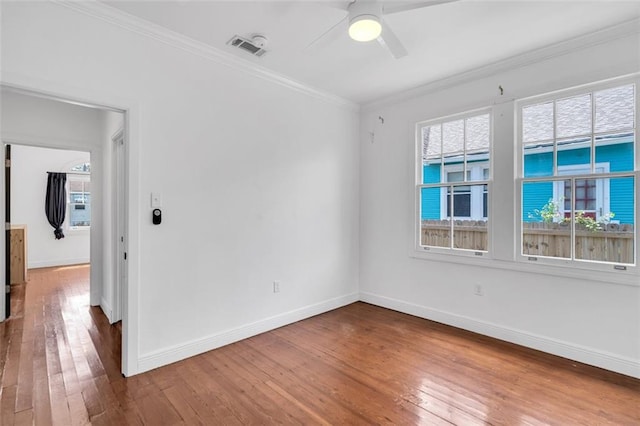 spare room featuring crown molding, ceiling fan, and wood-type flooring