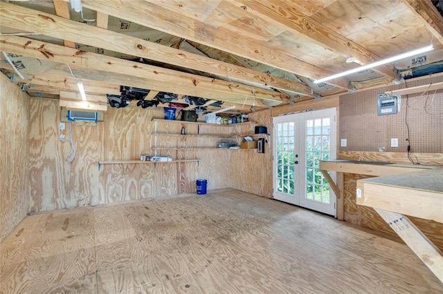 basement featuring french doors and a workshop area