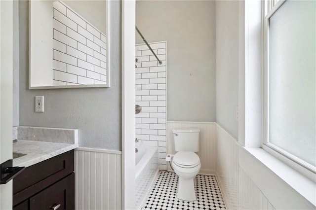 full bathroom featuring tiled shower / bath combo, tile patterned floors, toilet, and vanity