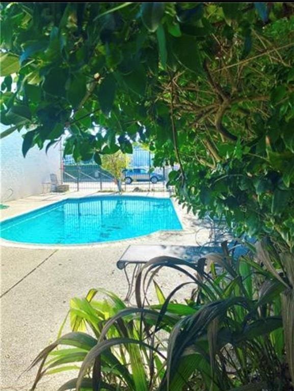 view of swimming pool with a fenced in pool, fence, and a patio