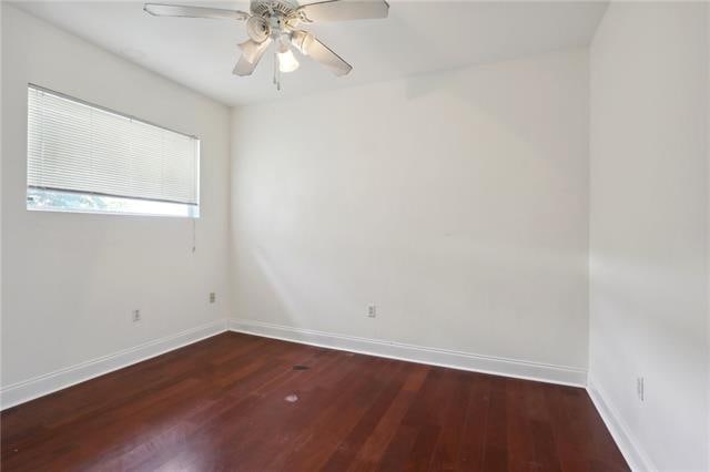 empty room with wood-type flooring and ceiling fan