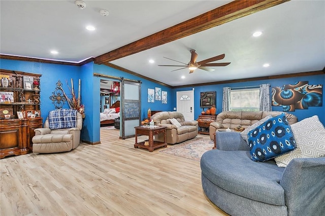 living room featuring ceiling fan, light hardwood / wood-style floors, lofted ceiling with beams, ornamental molding, and a barn door