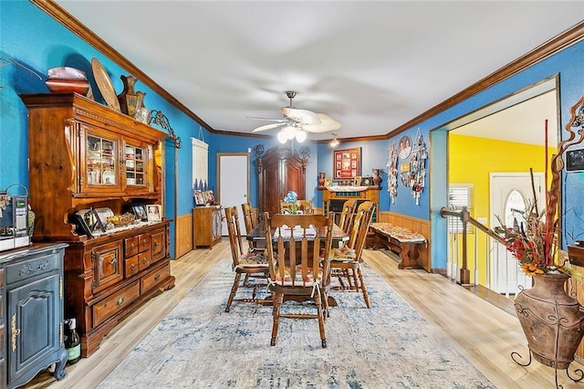 dining room with ornamental molding, light hardwood / wood-style floors, and ceiling fan