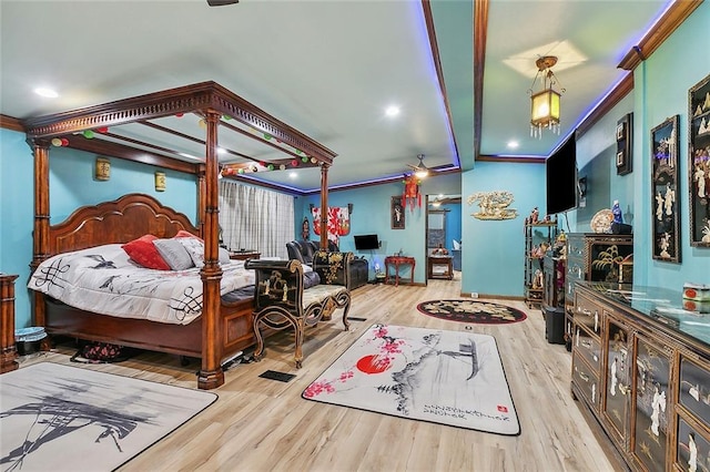 bedroom featuring ornamental molding, light hardwood / wood-style floors, and decorative columns