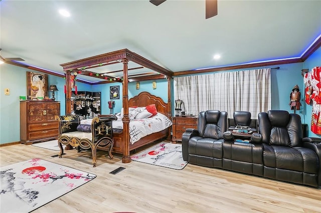 bedroom featuring crown molding, ceiling fan, and light hardwood / wood-style flooring