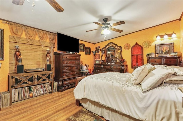 bedroom featuring crown molding, hardwood / wood-style flooring, and ceiling fan