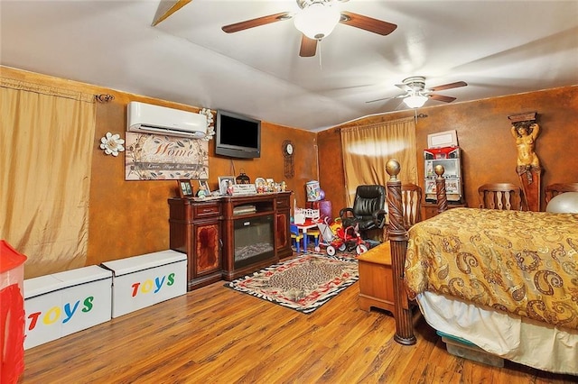 bedroom featuring lofted ceiling, a wall unit AC, and light hardwood / wood-style flooring