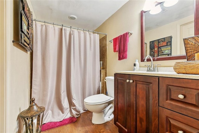 bathroom featuring vanity, hardwood / wood-style flooring, toilet, and a shower with shower curtain