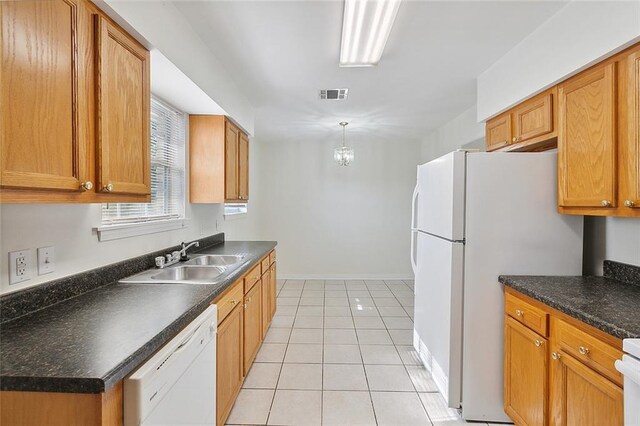 kitchen featuring light tile patterned floors, decorative light fixtures, white appliances, and sink