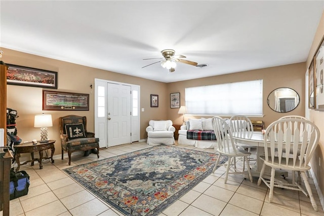 living room featuring light tile patterned flooring and ceiling fan