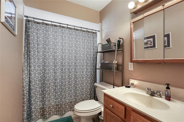 bathroom featuring vanity, toilet, and walk in shower