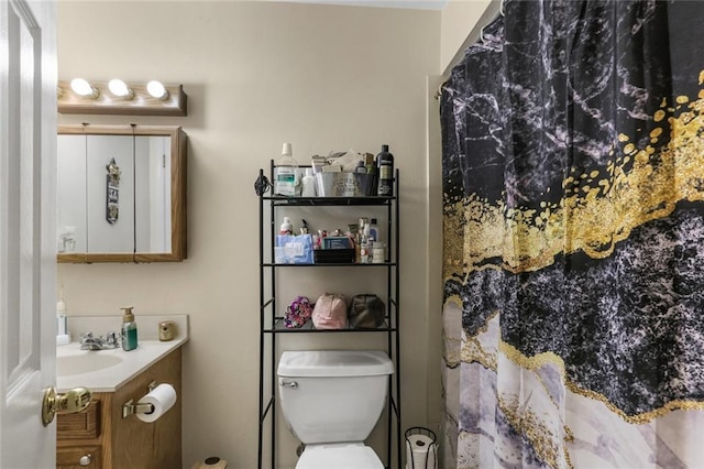 bathroom with walk in shower, vanity, and toilet