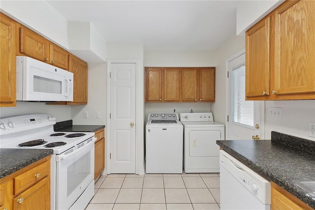 kitchen with light tile patterned flooring, white appliances, and separate washer and dryer