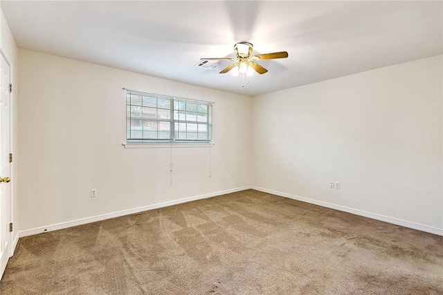 carpeted spare room featuring ceiling fan