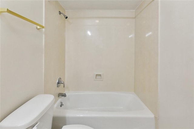 bathroom featuring shower / bathing tub combination and toilet