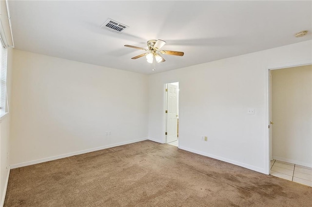 carpeted spare room featuring ceiling fan