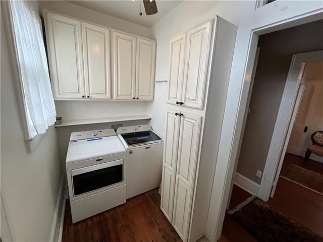 laundry room with cabinets, dark hardwood / wood-style flooring, washing machine and dryer, and ceiling fan