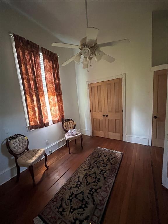 sitting room with ceiling fan and hardwood / wood-style flooring