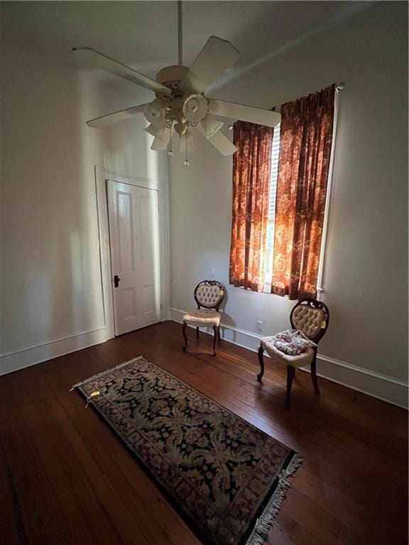 living area with hardwood / wood-style floors and ceiling fan