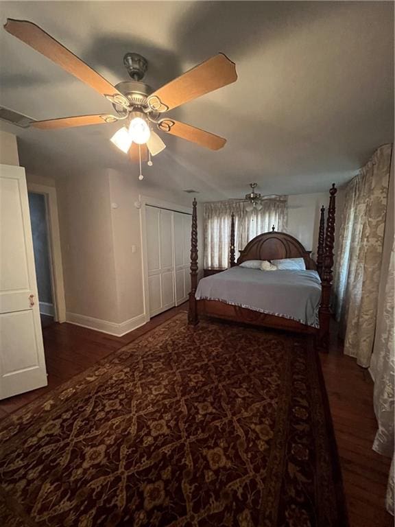 bedroom with ceiling fan and dark hardwood / wood-style flooring