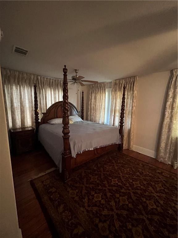 unfurnished bedroom featuring dark hardwood / wood-style flooring and ceiling fan