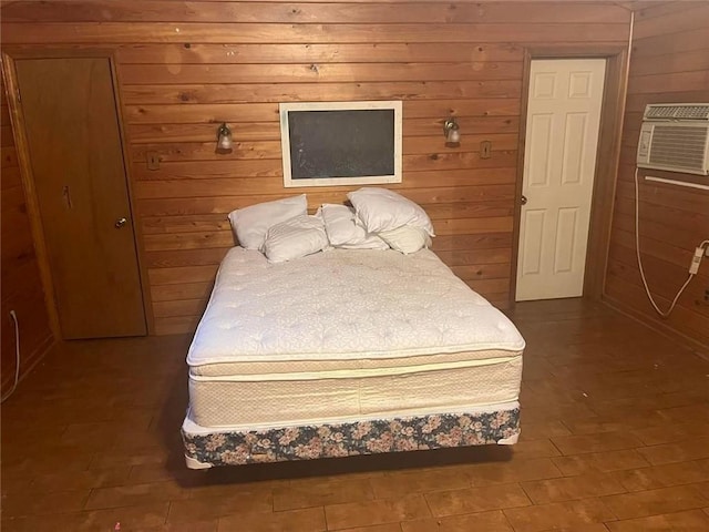 bedroom featuring a wall mounted AC and wood walls