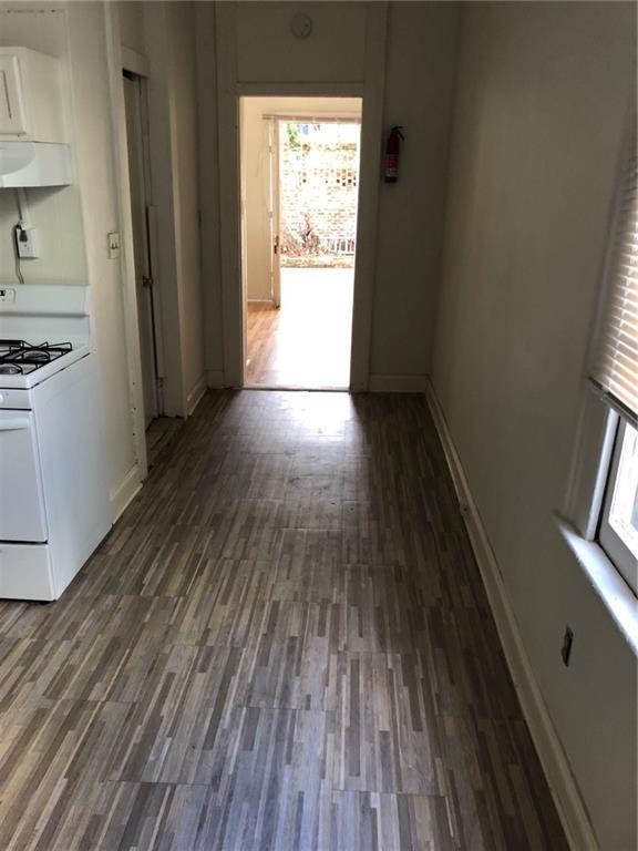 hallway featuring plenty of natural light and dark hardwood / wood-style flooring