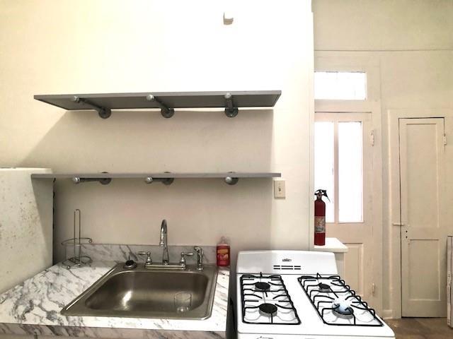 kitchen with sink, a healthy amount of sunlight, and range