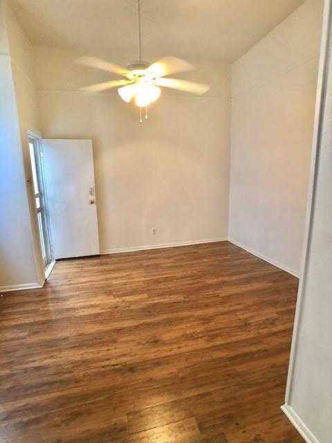 unfurnished room featuring ceiling fan and dark hardwood / wood-style flooring