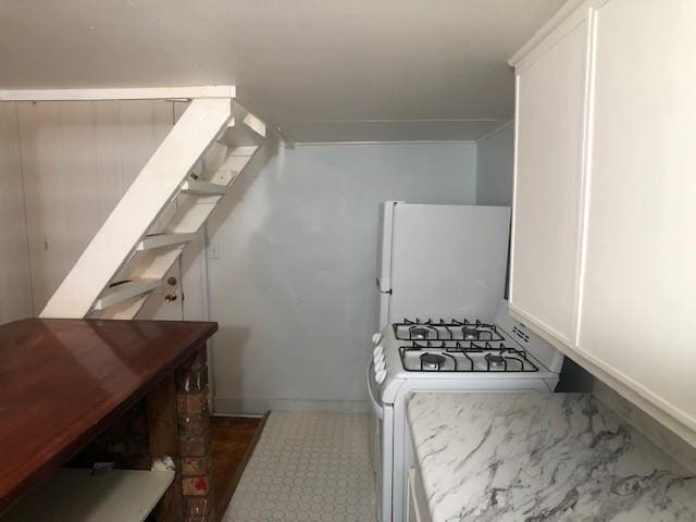 kitchen with white appliances and white cabinets