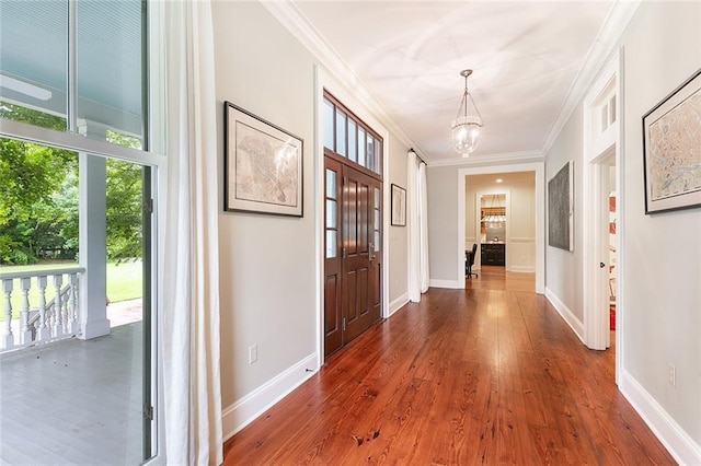 hall with crown molding and wood-type flooring