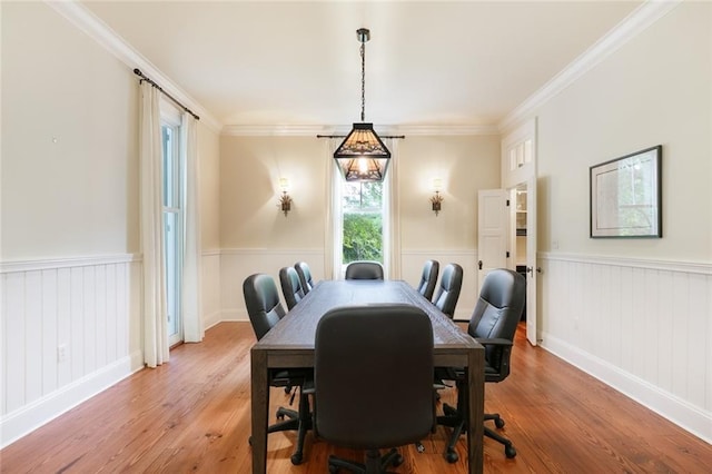 dining space featuring ornamental molding and wood-type flooring